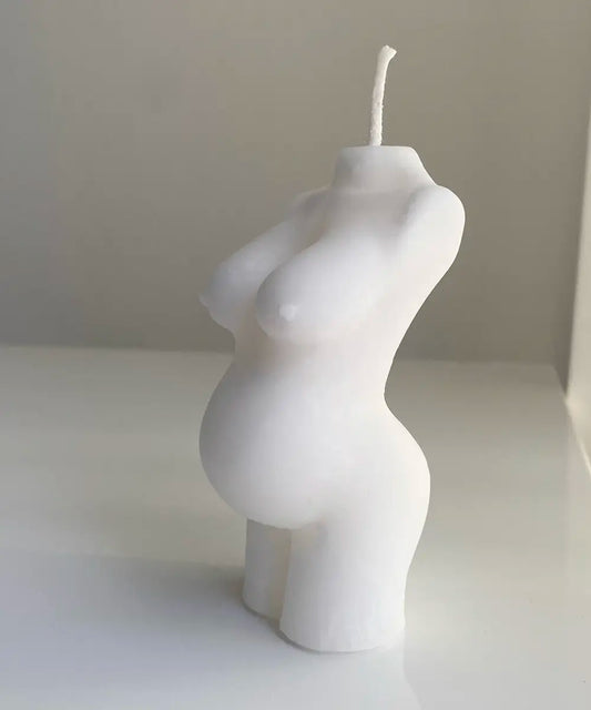 stearinljus i form av en gravid kvinnokropp